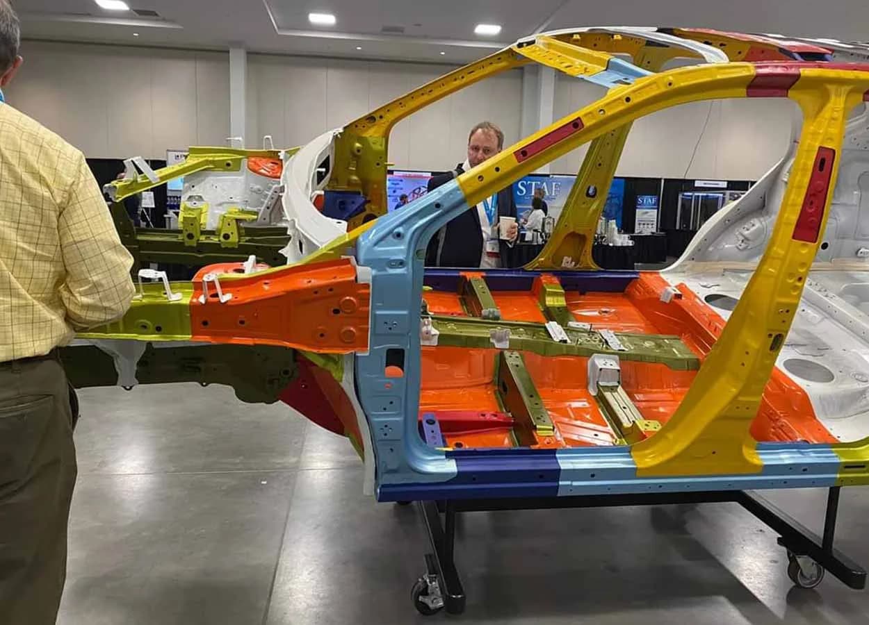 sectioned vehicle body structure on display at an automotive trade show